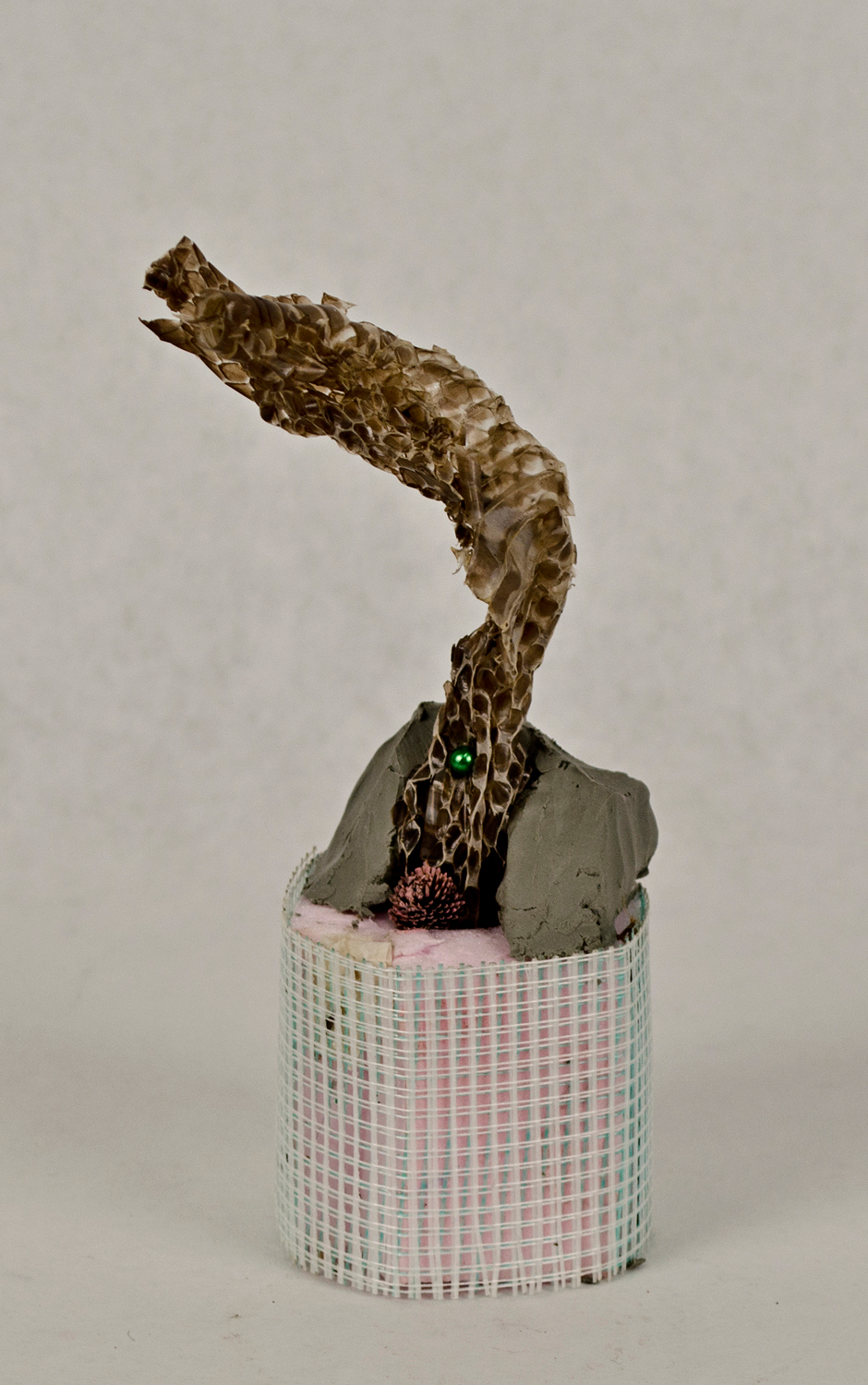 Jessica Lund, charmer, 2015. Foam, drywall tape, clay, snakeskin, flower, pin, paint, 7 x 3 x 3 in.