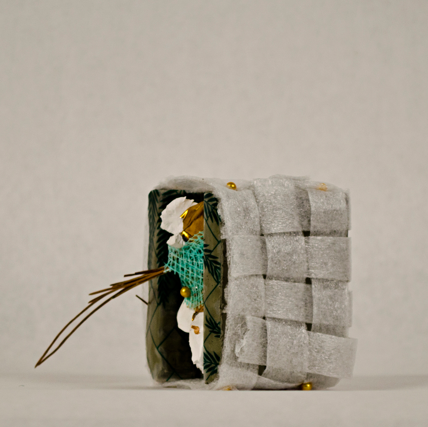 Jessica Lund, sushi, 2014. Paint, clay, foam, drywall tape, pine needles, pin, 4 x 3 x 2 in.