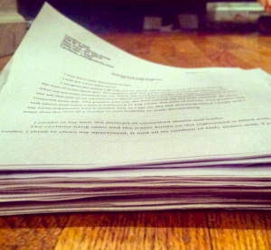 A stack of drafts, revisions, and suggested edits of a single 11-page short story. 
