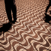 A red and white wavy tiled floor with two people walking