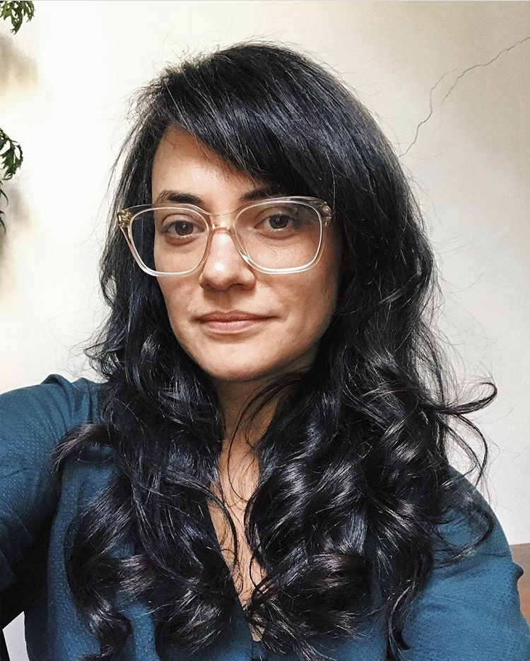 image of a person with long hair and wearing glasses