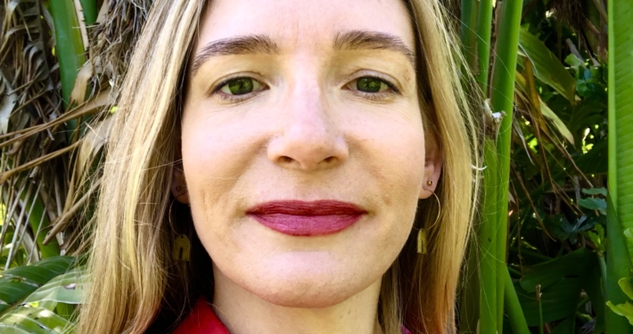 Rachel White Headshot person in fuchsia with green background