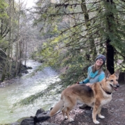 Deidre Cavazzi Author photo with dog near river
