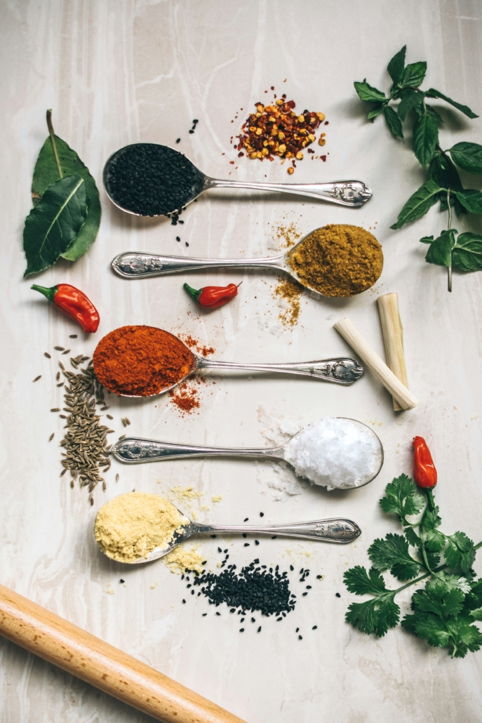 spoons of spices on white background