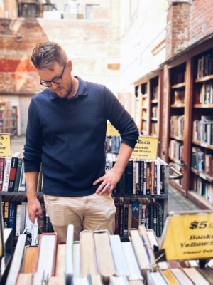 person looking at books in an alley Andrew Graham Martin author shot