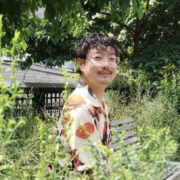 Chen Chen on a bench in the foliage