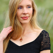 Image of a female in a black dress looking into the distance