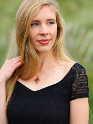 Image of a female in a black dress looking into the distance