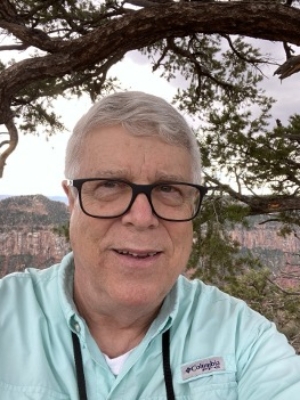 Person facing camera with canyons in the background