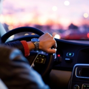 Person driving car with wristwatch