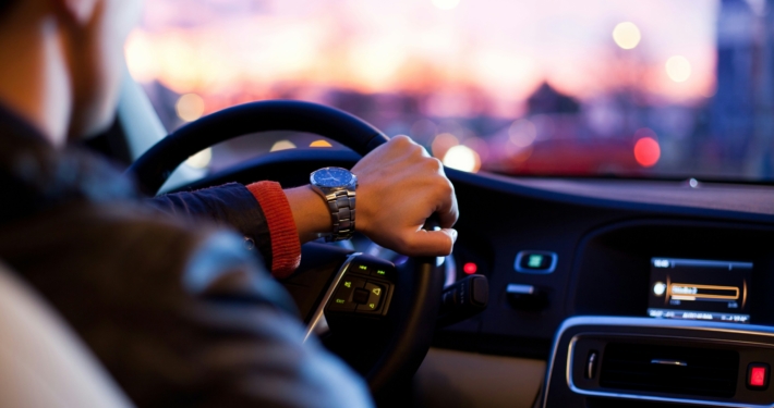 Person driving car with wristwatch