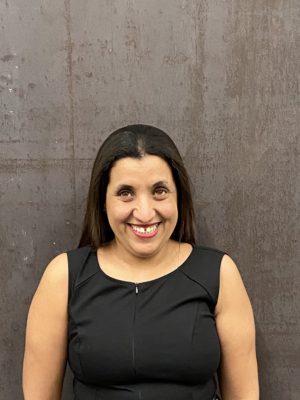 author smiling directly into the camera