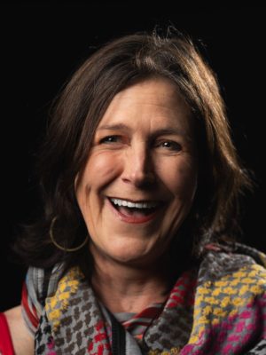 author smiling and looking into the camera