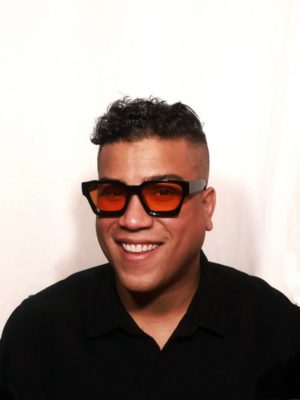 author wearing glasses and smiling into the camera